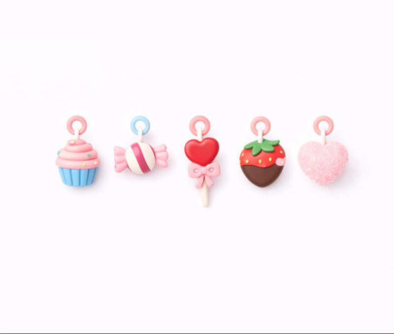 Set of colorful candy-shaped earrings on a white background