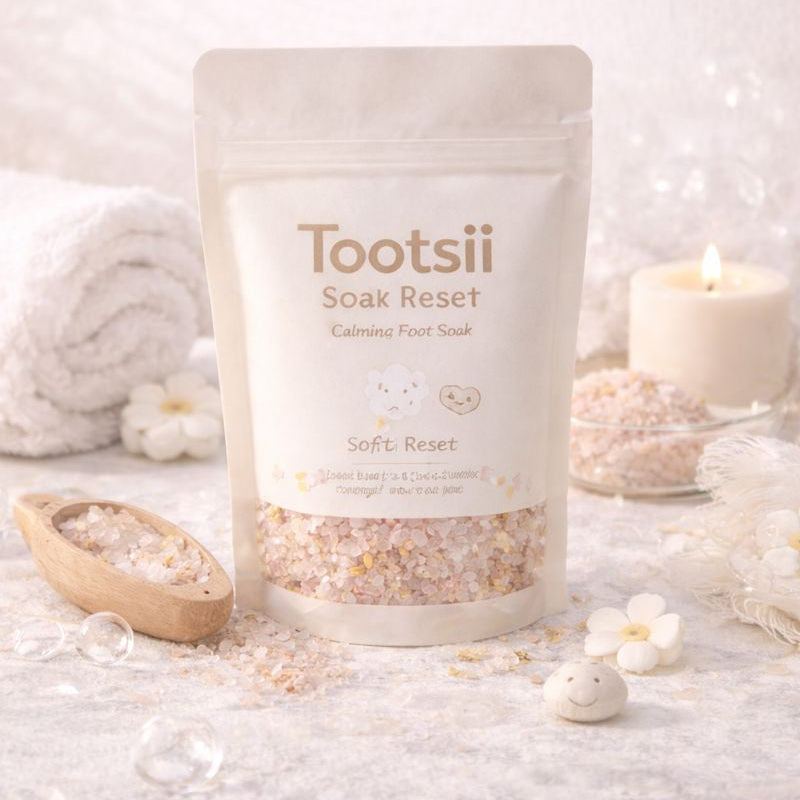 Tootsii Soak Reset product on a white surface with candles and flowers