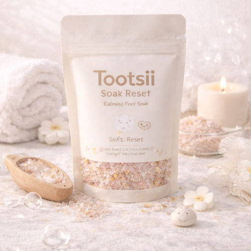 Tootsii Soak Reset product on a white surface with candles and flowers